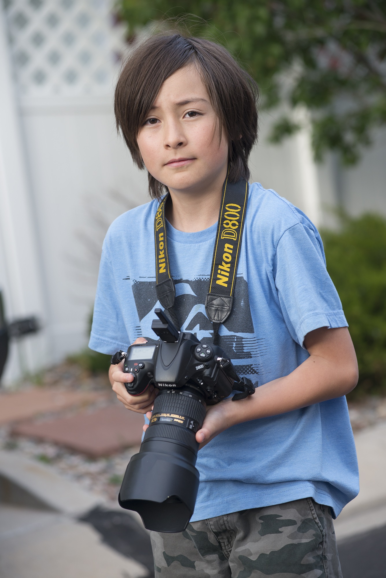 kid holding a Nikon D800 camera