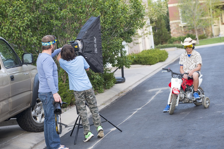 behind the scenes street shot of a kid riding a dirtbike