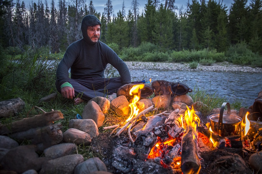 Photographer Sean F Boggs sitting by campfire